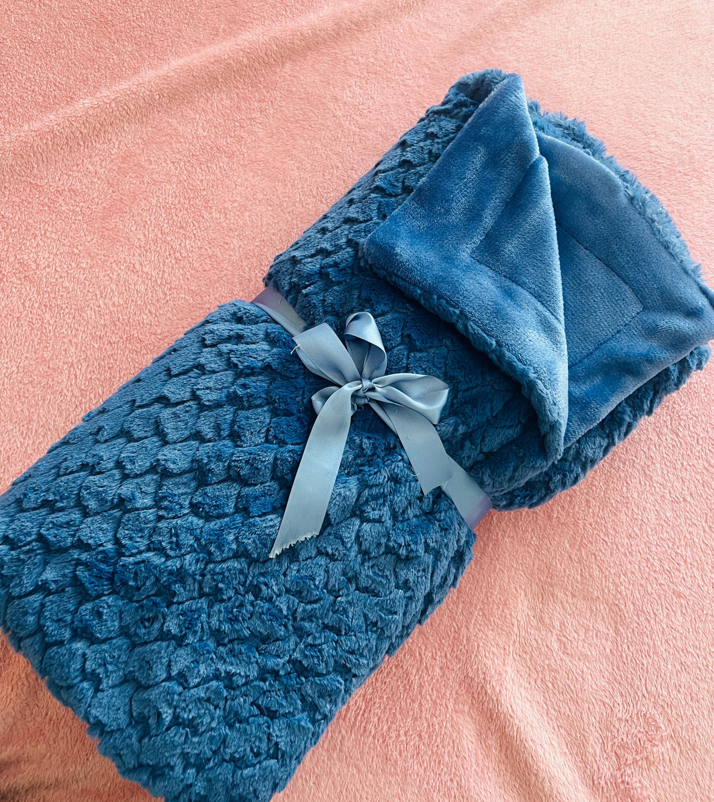 Blue blanket rolled with ribbon